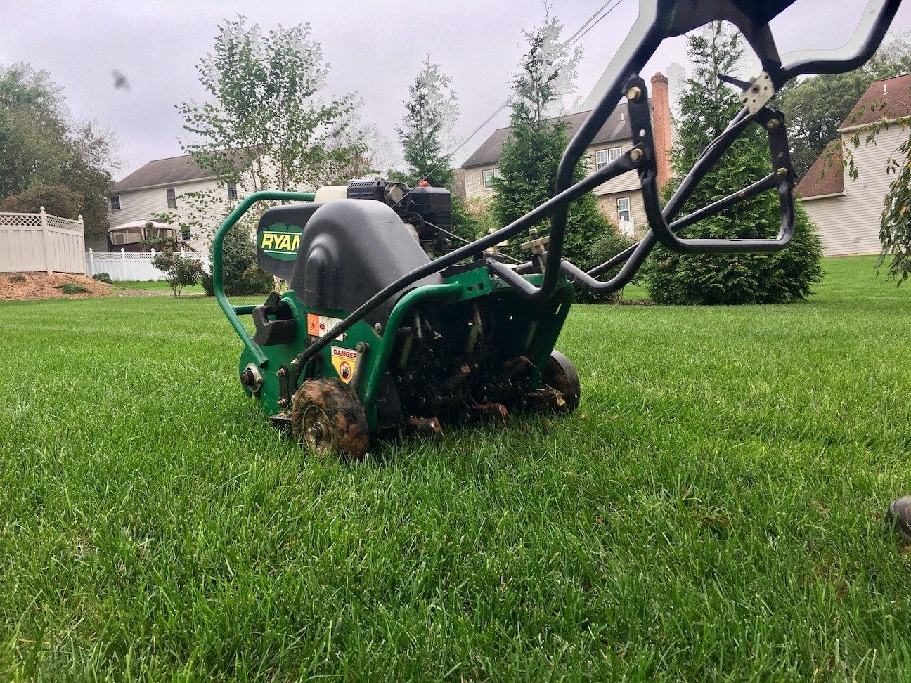 lawn care team member running an aerator through an idaho falls lawn