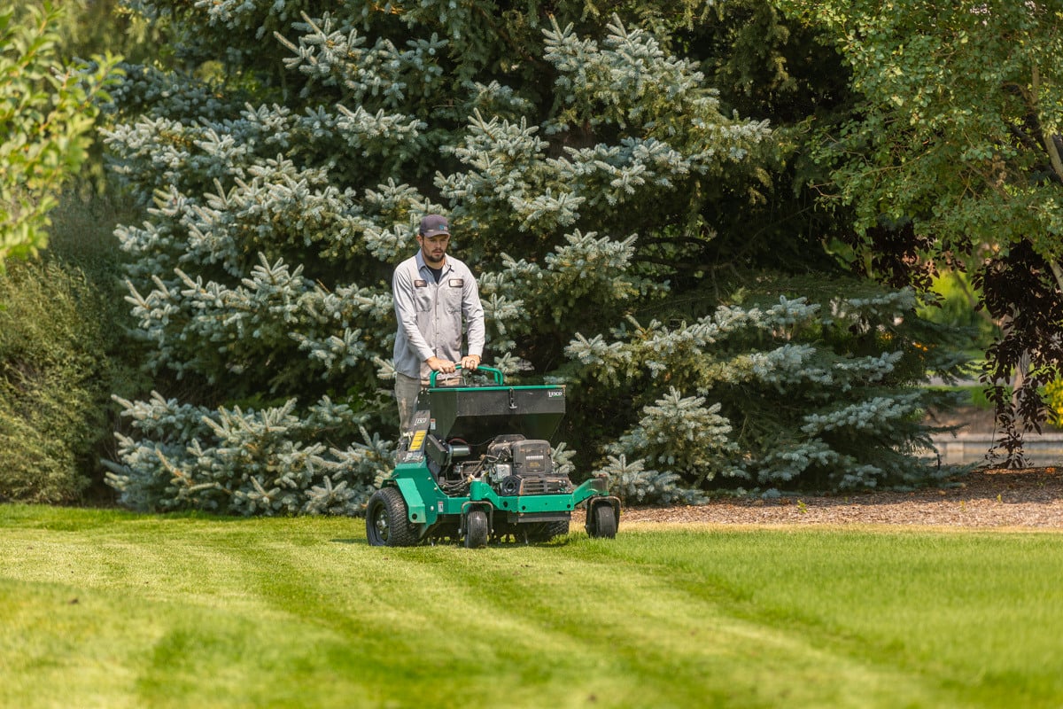 crew technician machine fertilizer green grass lawn turf lines action service 3